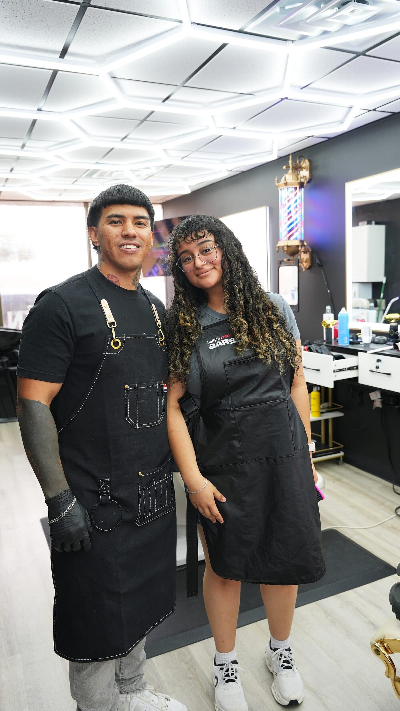 Two of the barbers at Oscar A. Barber